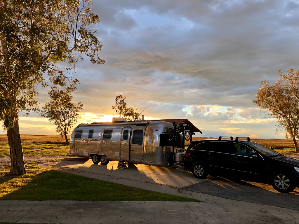 Vintage Airstream parked beside wildflower meadow