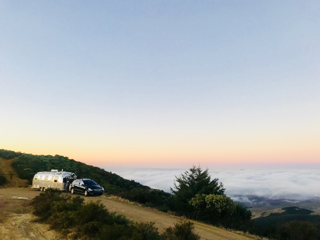 Family camping with renovated Airstream in national forest