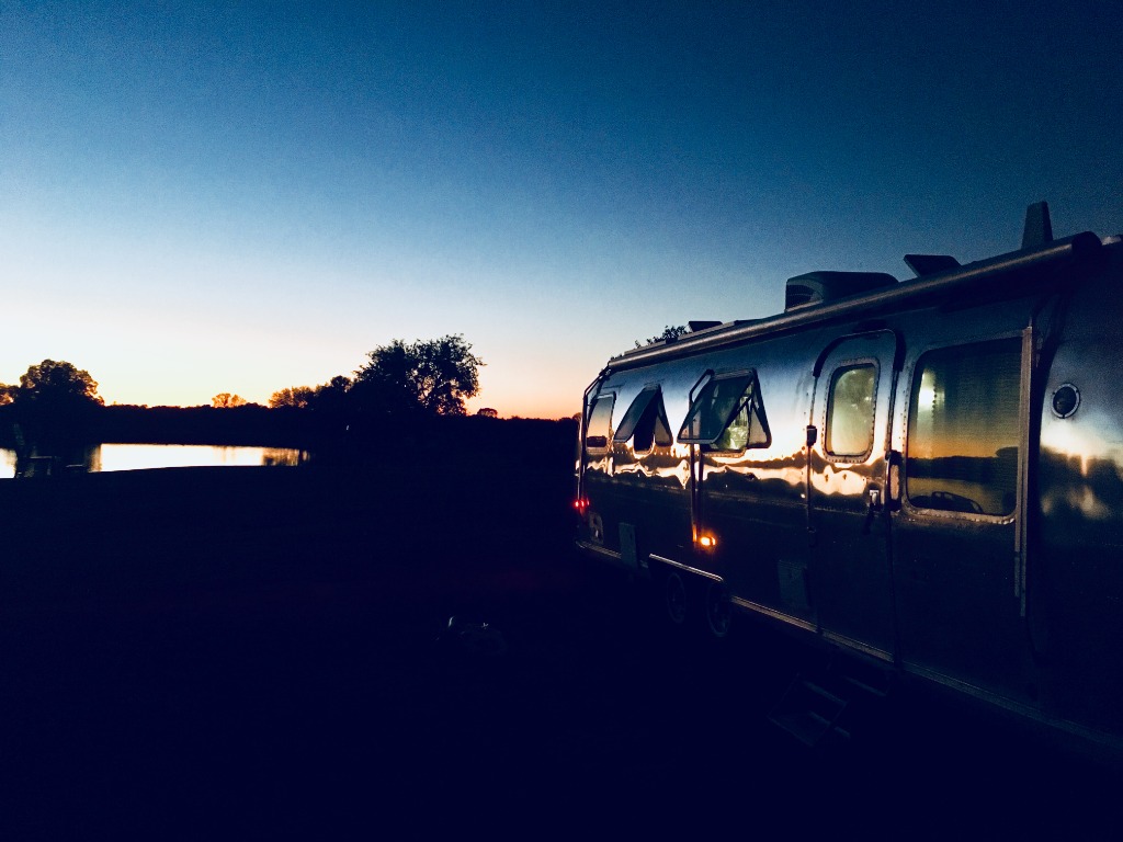 Airstream Excella parked at sunset with golden hour lighting